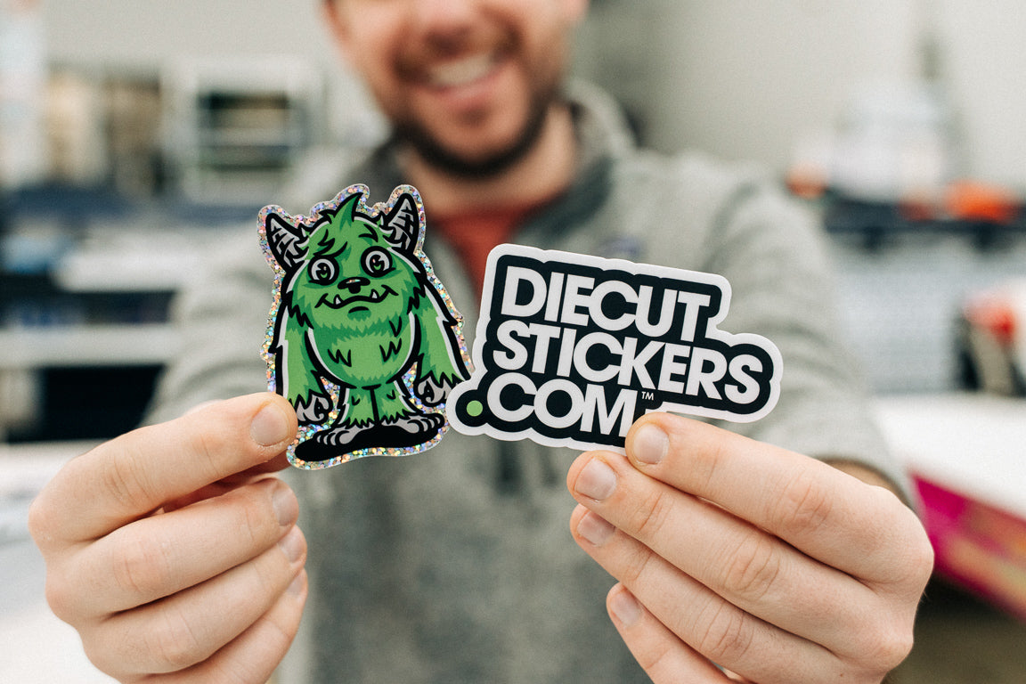 Person holding a green diecut sticker with 'Diecut Stickers.com' text