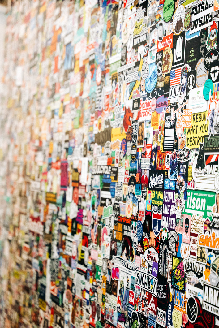 Wall covered with a large number of colorful stickers