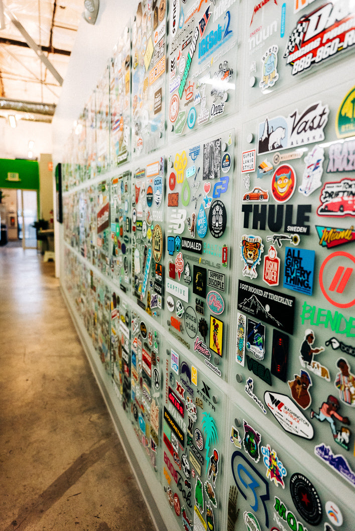 Wall covered with various stickers and decals