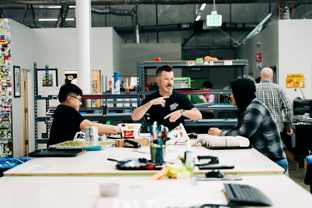 People gathered around a table in a workshop or office setting