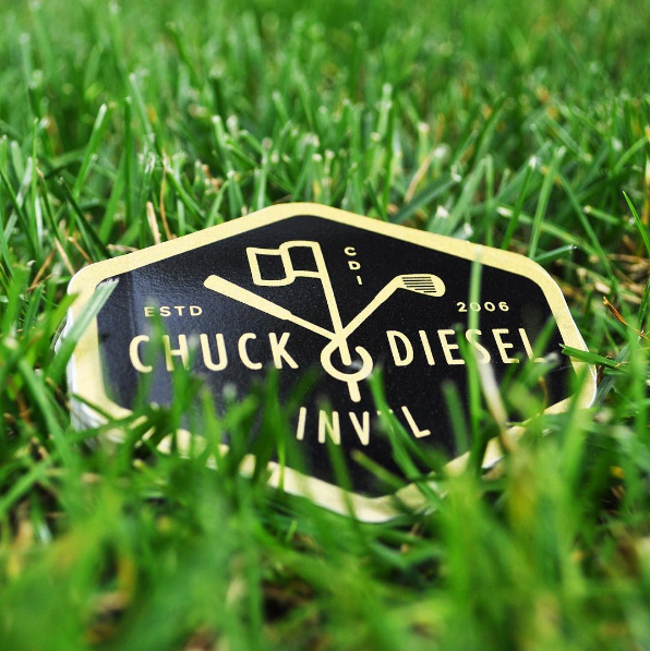 Gold and Black Chuck Diesel Golf Tournament sticker on golf course
