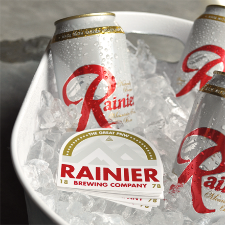 Two Rainier beer cans in a bowl of ice.